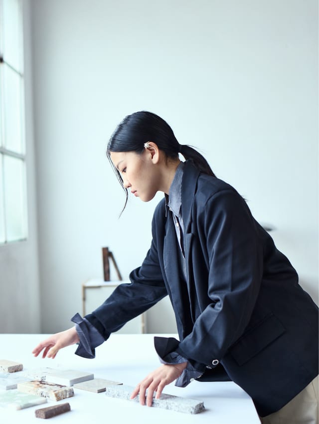 Designer laying out a model on a studio table