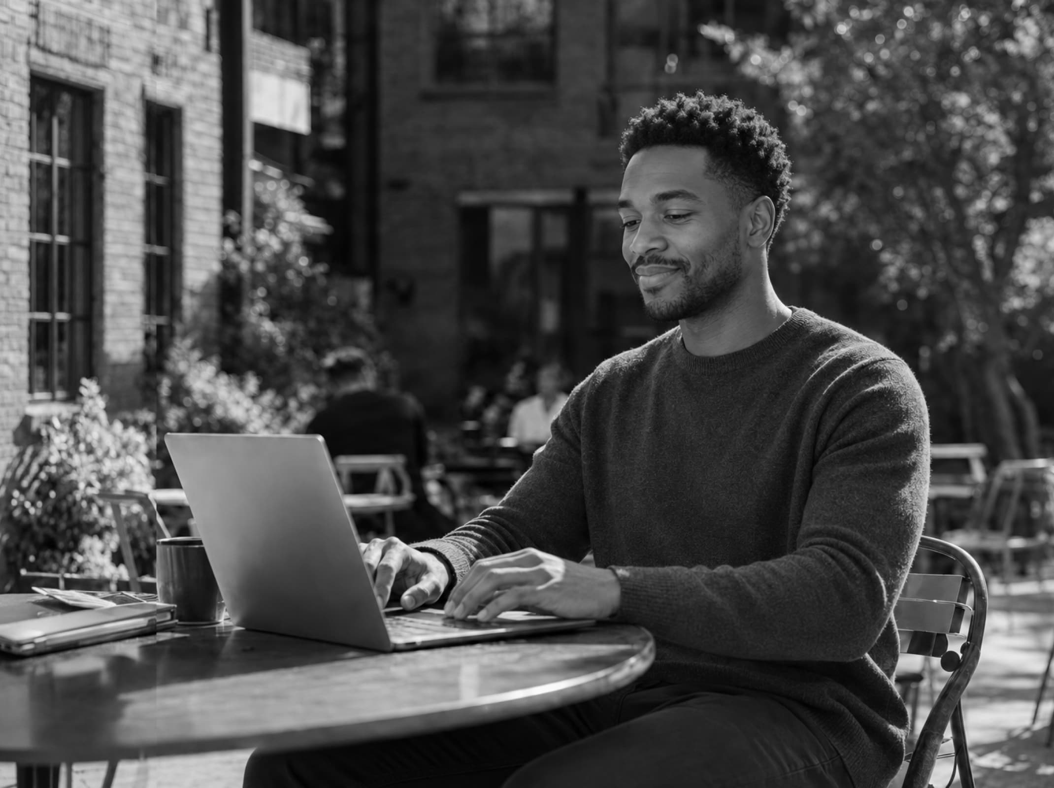 Small business owner applying for funding on a laptop at a cafe